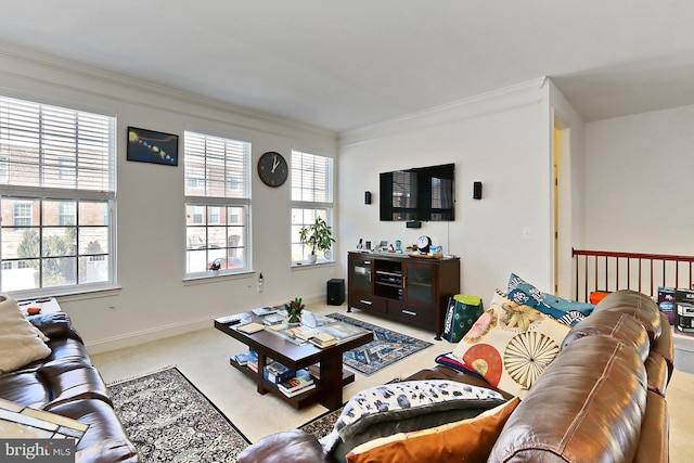 living room featuring ornamental molding, a healthy amount of sunlight, light carpet, and baseboards