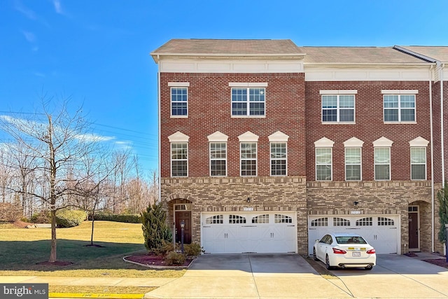 multi unit property with driveway, brick siding, and a front lawn