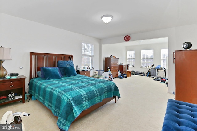 bedroom featuring light colored carpet