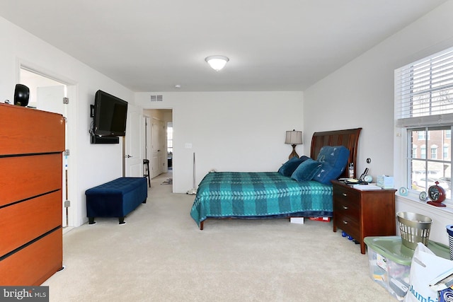 bedroom with visible vents and light colored carpet