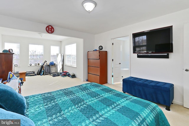 bedroom with baseboards and light colored carpet