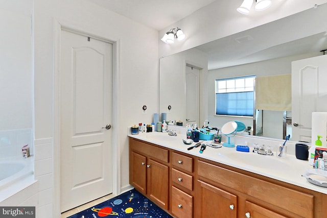 bathroom featuring a bathtub, a sink, and double vanity