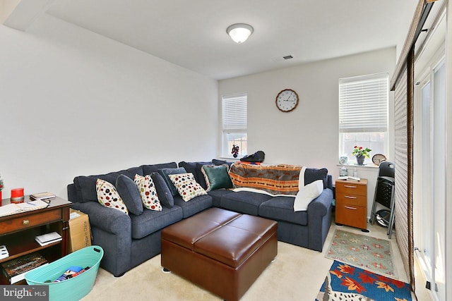 living room with light carpet and visible vents