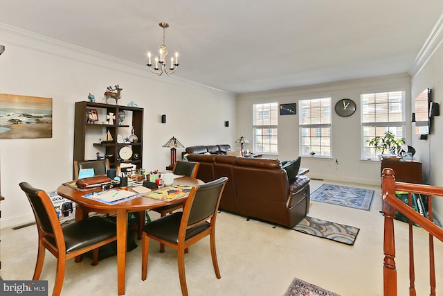 dining room with baseboards, an inviting chandelier, light colored carpet, and crown molding