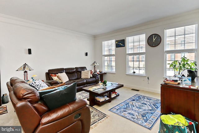 carpeted living area with visible vents, crown molding, and baseboards