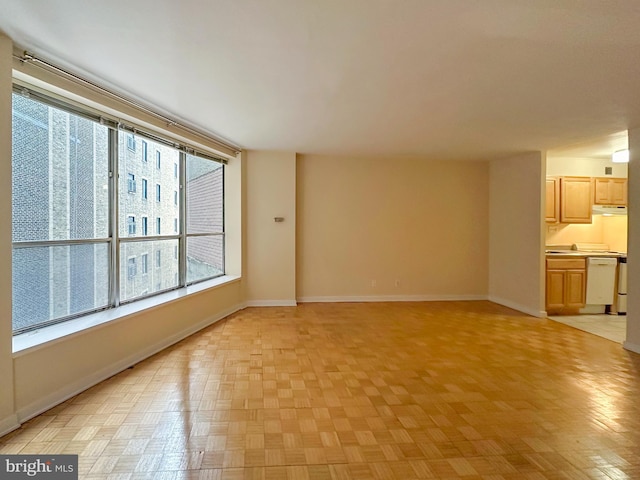 unfurnished living room with baseboards