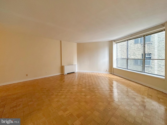 unfurnished room with baseboards