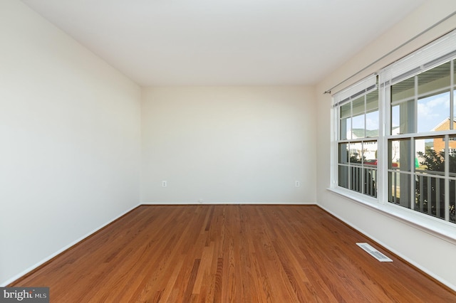 unfurnished room with hardwood / wood-style floors