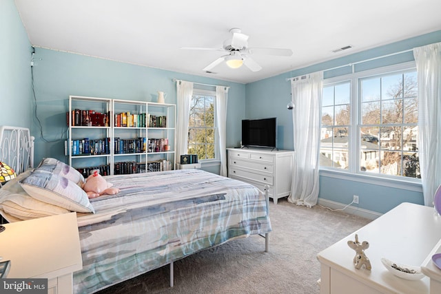 bedroom with light carpet, baseboards, a ceiling fan, and visible vents