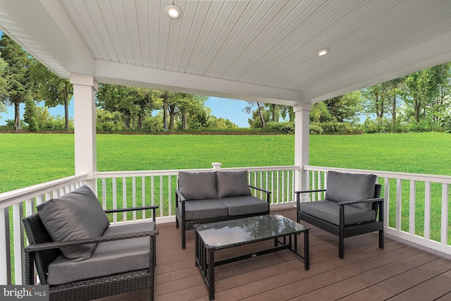 wooden deck with an outdoor hangout area and a lawn