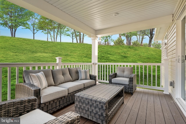 wooden terrace with a lawn and outdoor lounge area