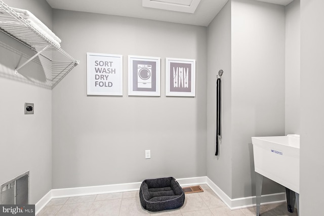 clothes washing area featuring light tile patterned flooring, laundry area, visible vents, baseboards, and electric dryer hookup