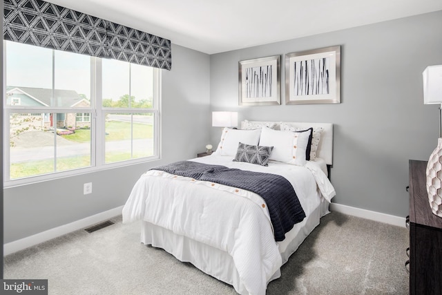 bedroom featuring carpet, visible vents, and baseboards