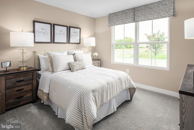 bedroom featuring carpet and baseboards