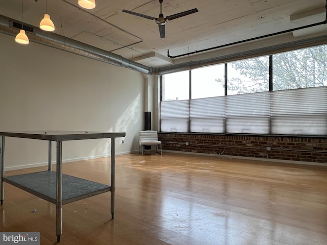 unfurnished sunroom with visible vents and ceiling fan