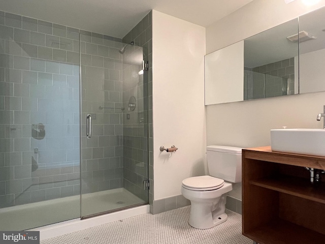 bathroom featuring baseboards, tile patterned flooring, toilet, and a shower stall