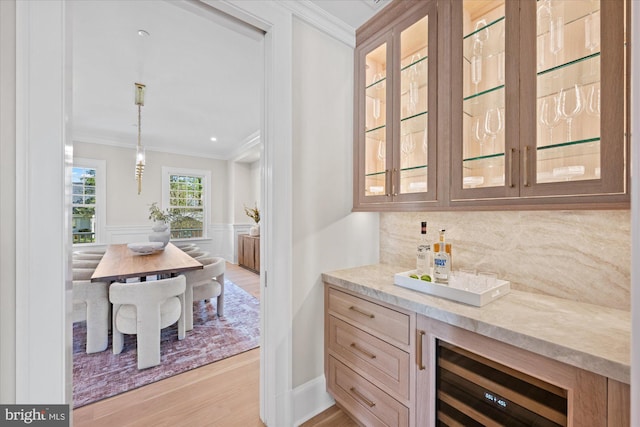 5408 Moorland Ln, Bethesda, MD 20814 - bar with beverage cooler, ornamental molding, backsplash, light wood-type flooring, and decorative light fixtures