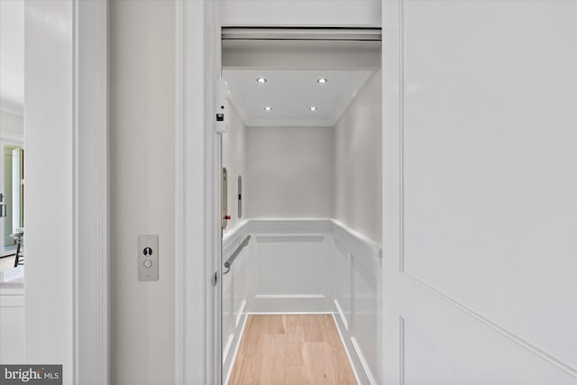 5408 Moorland Ln, Bethesda, MD 20814 - elevator featuring wood finished floors, crown molding, a wainscoted wall, recessed lighting, and a decorative wall