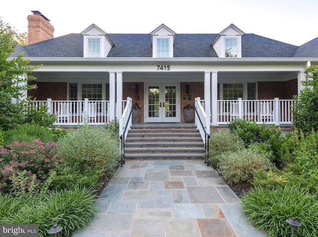 5408 Moorland Ln, Bethesda, MD 20814 - cape cod home with french doors, brick siding, covered porch, and a chimney