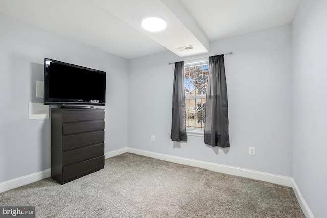 unfurnished bedroom with baseboards, visible vents, and carpet flooring