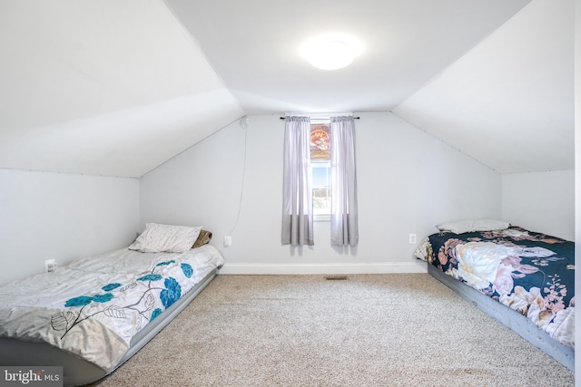 bedroom featuring baseboards, vaulted ceiling, and carpet flooring