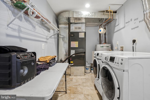 laundry area featuring laundry area, independent washer and dryer, visible vents, and heating unit