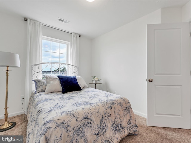 bedroom featuring light carpet