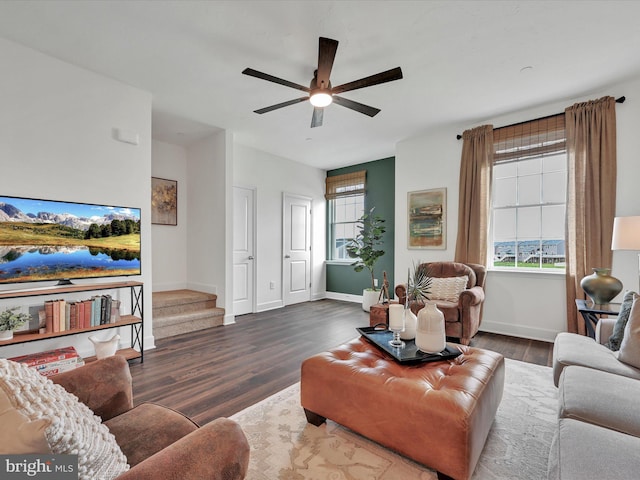 living room with plenty of natural light, ceiling fan, and dark hardwood / wood-style floors