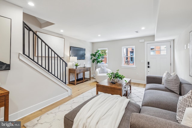 living room with light wood-type flooring and a wealth of natural light