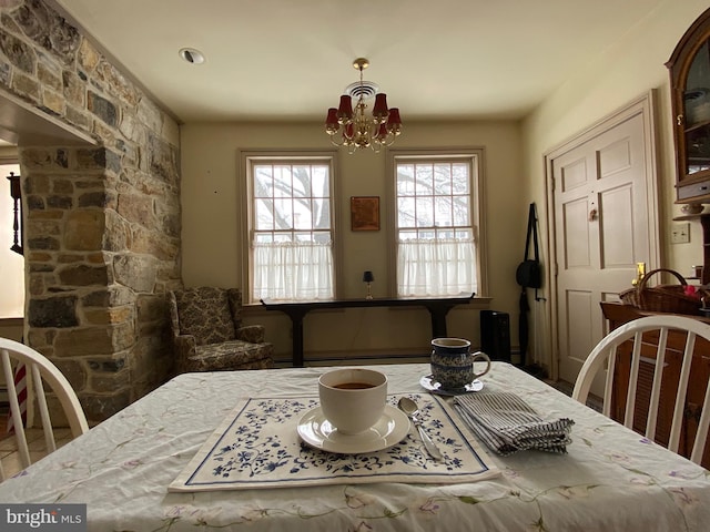 dining area with an inviting chandelier