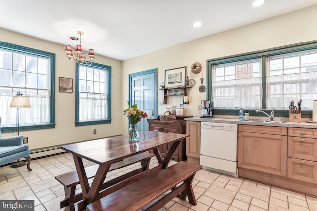 kitchen featuring light brown cabinets, light countertops, an inviting chandelier, white dishwasher, and a sink