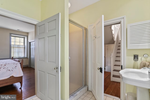 ensuite bathroom featuring a shower stall, tile patterned floors, visible vents, and ensuite bathroom