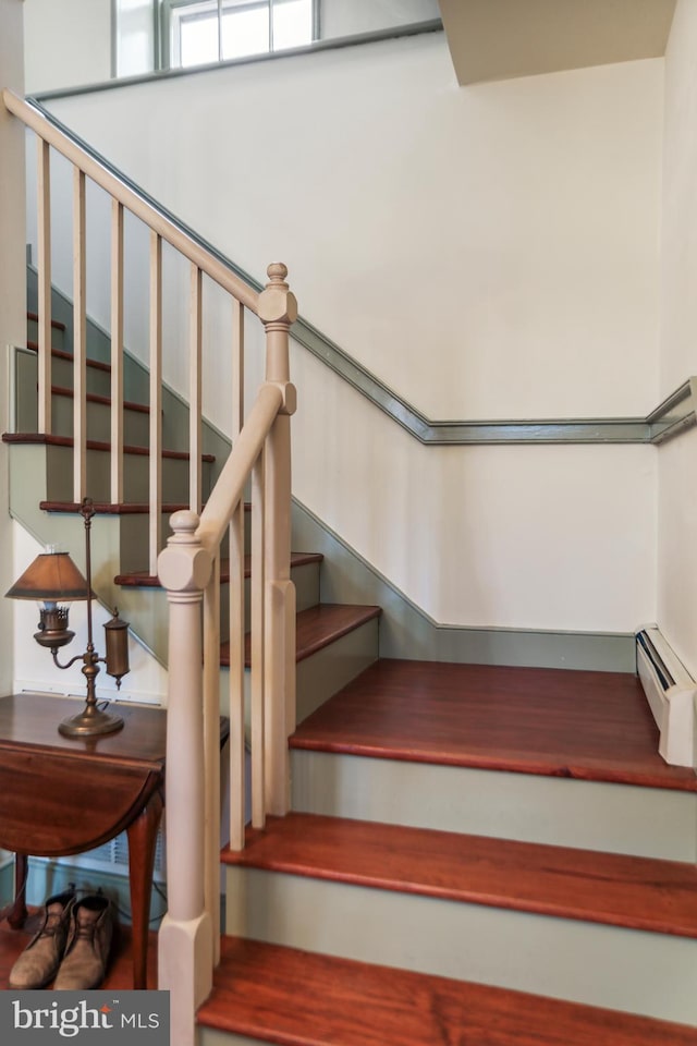 stairs featuring baseboard heating