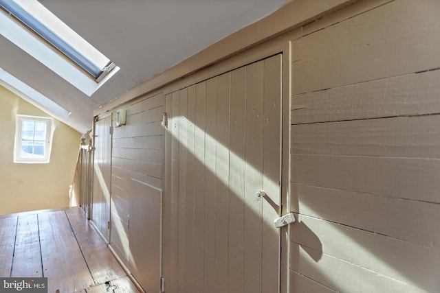 interior space featuring wood finished floors and a skylight