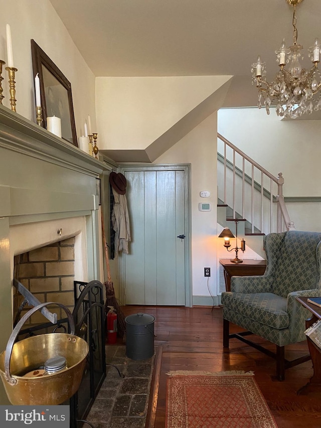 interior space featuring hardwood / wood-style floors, stairway, and a notable chandelier