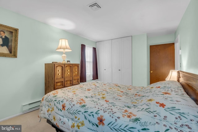 bedroom with a baseboard radiator, a closet, light carpet, and visible vents