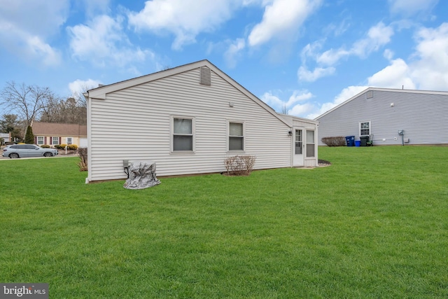 rear view of property with a lawn