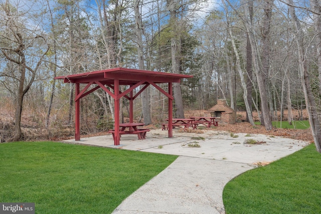 view of yard with a patio area and a fireplace