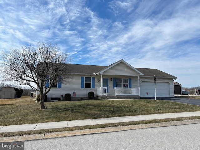 ranch-style home featuring a garage, a front yard, a storage shed, and a porch