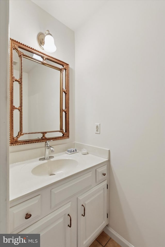 bathroom with vanity, baseboards, and tile patterned floors