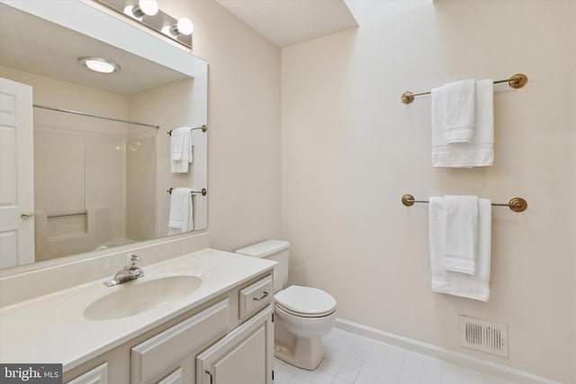 bathroom with toilet, vanity, visible vents, baseboards, and walk in shower