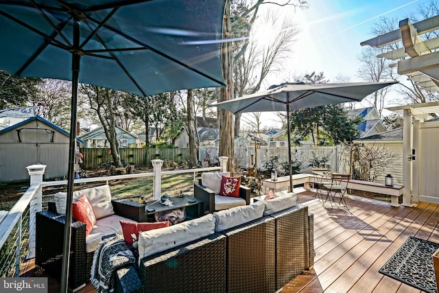 wooden terrace with a storage shed, a fenced backyard, outdoor lounge area, and an outdoor structure