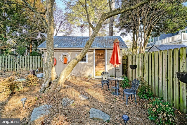 view of outbuilding featuring an outdoor structure and a fenced backyard