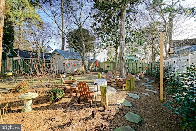 view of yard featuring an outbuilding and fence