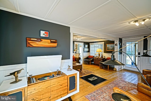 interior space with wainscoting, wood finished floors, and a wealth of natural light