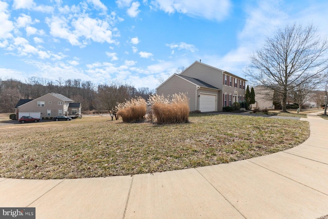 view of side of property with a garage and a yard