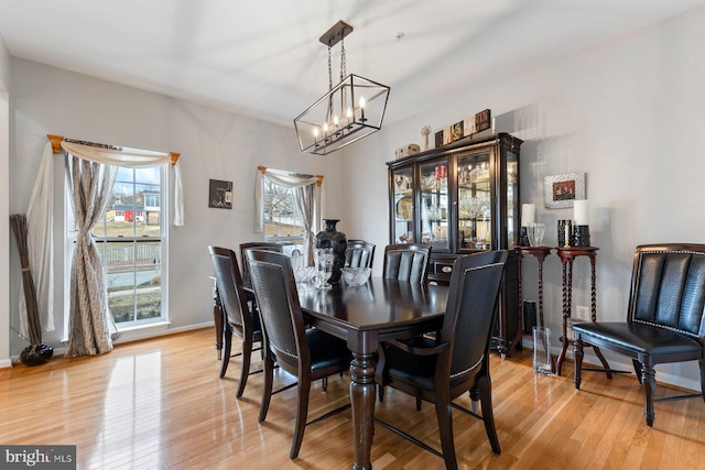 dining space featuring light wood finished floors and baseboards