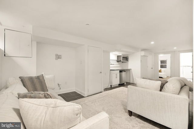 tiled living room featuring baseboards and recessed lighting