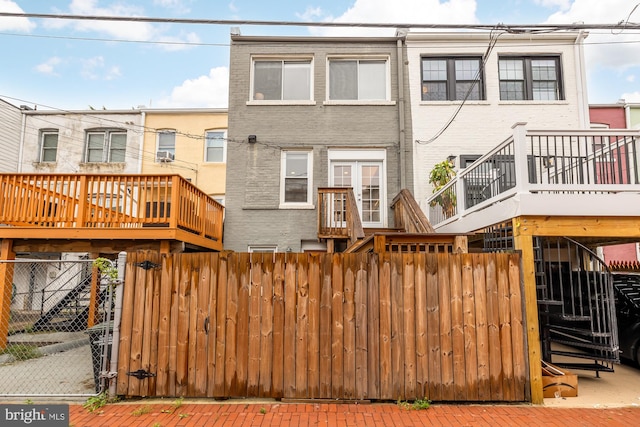 back of house with fence and brick siding