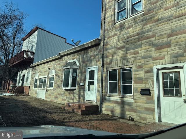 view of side of property with stone siding